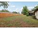 Large backyard features a wood fence and partial sun, offering plenty of room for outdoor activities at 4145 Dora Wood Dr, Mount Dora, FL 32757