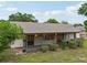 View of the home's backyard, highlighting the screened in porch, yard, and mature trees at 4145 Dora Wood Dr, Mount Dora, FL 32757