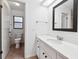 Bright bathroom with a tiled floor, vanity, toilet, and shower visible through an open door at 4145 Dora Wood Dr, Mount Dora, FL 32757