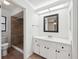 Bathroom with a tiled shower, toilet, and vanity with solid surface countertops at 4145 Dora Wood Dr, Mount Dora, FL 32757