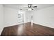Bedroom with wood floors, a ceiling fan, an ensuite bathroom, and a view of other rooms at 4145 Dora Wood Dr, Mount Dora, FL 32757