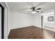 Bright bedroom showcasing wood floors, ceiling fan, and an attached bathroom with a vanity at 4145 Dora Wood Dr, Mount Dora, FL 32757