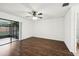 Light-filled bedroom featuring wood floors, ceiling fan, and sliding glass doors to the patio at 4145 Dora Wood Dr, Mount Dora, FL 32757