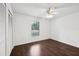 Bedroom with hardwood floors, ceiling fan, and a window at 4145 Dora Wood Dr, Mount Dora, FL 32757