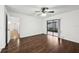 Large bedroom with wood floors, ceiling fan, and sliding glass doors leading to an outdoor area at 4145 Dora Wood Dr, Mount Dora, FL 32757