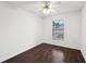 This bedroom features hard wood floors, a ceiling fan, and a window offering natural light at 4145 Dora Wood Dr, Mount Dora, FL 32757