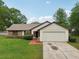 Charming home features a brick walkway, attached garage, and well-maintained landscaping for a welcoming entrance at 4145 Dora Wood Dr, Mount Dora, FL 32757