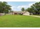Inviting single-Gathering home with lush green lawn, mature trees, and a driveway leading to a two-car garage at 4145 Dora Wood Dr, Mount Dora, FL 32757