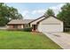 Charming single-story home featuring a well-manicured lawn, brick accents, and an attached two-car garage at 4145 Dora Wood Dr, Mount Dora, FL 32757