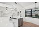 Open-concept kitchen with stainless dishwasher, sleek countertops, and sink with backyard views at 4145 Dora Wood Dr, Mount Dora, FL 32757