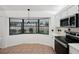 Kitchen with stainless steel appliances, tile floors, and an over-the-sink window to the backyard at 4145 Dora Wood Dr, Mount Dora, FL 32757