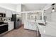 Open kitchen showcasing stainless steel appliances, white cabinets, and a breakfast bar at 4145 Dora Wood Dr, Mount Dora, FL 32757
