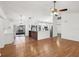 Open living space featuring wood floors, vaulted ceilings, a kitchen view, and sliding doors to the outside at 4145 Dora Wood Dr, Mount Dora, FL 32757