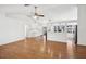 Bright and open-concept living area featuring hardwood floors and a view into the adjacent kitchen at 4145 Dora Wood Dr, Mount Dora, FL 32757