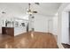 Spacious living room with hardwood flooring, vaulted ceilings, and an open view into the well-lit kitchen at 4145 Dora Wood Dr, Mount Dora, FL 32757