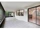 Covered patio features tile flooring and sliding glass doors leading to the kitchen at 4145 Dora Wood Dr, Mount Dora, FL 32757