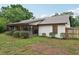 Home's back exterior features a screened lanai and well-maintained landscaping, perfect for enjoying the outdoors at 4145 Dora Wood Dr, Mount Dora, FL 32757