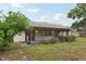 Home's back exterior features a screened lanai and well-maintained landscaping, perfect for enjoying the outdoors at 4145 Dora Wood Dr, Mount Dora, FL 32757