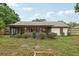 Home's back exterior features a screened lanai and well-maintained landscaping, perfect for enjoying the outdoors at 4145 Dora Wood Dr, Mount Dora, FL 32757