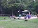 Spacious backyard area with a grill, table, umbrella, and visiting wild turkeys at 4746 Cr 300, Lake Panasoffkee, FL 33538