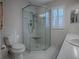 Clean bathroom showcasing a tiled shower, toilet, and vanity with sink at 507 Torres Pl, The Villages, FL 32159