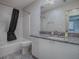 Bathroom features a bathtub with a shower, a mirror, and a granite countertop on the vanity at 507 Torres Pl, The Villages, FL 32159