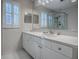 Bright bathroom features a vanity with a white countertop and a large mirror at 507 Torres Pl, The Villages, FL 32159