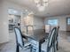 Bright dining area with tile floors, chandelier, and an open transition to the kitchen at 507 Torres Pl, The Villages, FL 32159