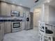 Modern kitchen featuring stainless steel appliances, granite countertops, and ample cabinet space at 507 Torres Pl, The Villages, FL 32159