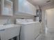 Laundry area features washer, dryer, utility sink and white cabinets at 507 Torres Pl, The Villages, FL 32159