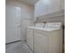 Laundry room featuring a washer, dryer, overhead cabinets, and tiled floors at 507 Torres Pl, The Villages, FL 32159