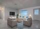 Inviting living room with tile floors, neutral colors, ample natural light, and comfortable seating at 507 Torres Pl, The Villages, FL 32159