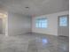 Bright, empty living room boasts neutral colors, natural light, and tile flooring at 507 Torres Pl, The Villages, FL 32159