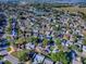 This is an aerial view of the property showing its location in a community with mature trees at 507 Torres Pl, The Villages, FL 32159