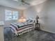 Comfortable bedroom featuring a decorative ceiling fan and large window at 507 Torres Pl, The Villages, FL 32159
