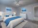 Well-lit bedroom with neutral colors, white furniture, and blue accents at 507 Torres Pl, The Villages, FL 32159