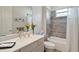 Bright bathroom featuring a large mirror, white cabinets, and a combined shower and bathtub at 5195 Greens Dr, Lady Lake, FL 32159