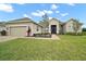 Beautiful single-story home with lush green lawn and manicured landscaping at 5195 Greens Dr, Lady Lake, FL 32159