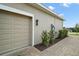 Spacious two-car garage with brick paver driveway and manicured landscaping at 5195 Greens Dr, Lady Lake, FL 32159