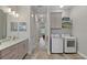 Hallway with laundry area, sink, cabinets, washer, and dryer at 5195 Greens Dr, Lady Lake, FL 32159