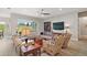Bright, open living space with large windows, comfortable seating, and views of the lush green landscape at 5195 Greens Dr, Lady Lake, FL 32159