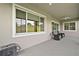 Covered patio with ceiling fans and outdoor seating, perfect for relaxation at 5195 Greens Dr, Lady Lake, FL 32159