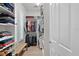 Walk-in closet with ample storage space, shelving, and plenty of room for clothing at 5195 Greens Dr, Lady Lake, FL 32159