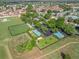 Community aerial view showcasing the shuffleboard, clubhouse, pool, amenities, and surrounding neighborhood at 530 Valencia Pl, The Villages, FL 32159