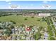 Aerial view of neighborhood in The Villages, FL, showcasing Rio Grande Gathering Pool, Polo Club, and Lake Sumter Landing at 530 Valencia Pl, The Villages, FL 32159
