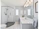 Bright bathroom with glass enclosed shower and white vanity with large mirror at 530 Valencia Pl, The Villages, FL 32159