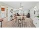Open dining area with wood floors, a dining table, and a view into the living room at 530 Valencia Pl, The Villages, FL 32159