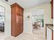 Pantry and eat in kitchen featuring white tile floors and cherry cabinets at 530 Valencia Pl, The Villages, FL 32159