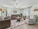 Comfortable living room with neutral decor, wood floors, and ample seating space at 530 Valencia Pl, The Villages, FL 32159