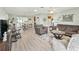 Spacious living area with wood floors, ceiling fan, and plenty of natural light at 530 Valencia Pl, The Villages, FL 32159
